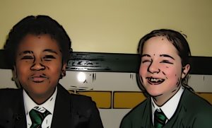 Two children next to each other are smiling