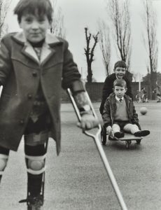 Child with crutch in old black and white photo