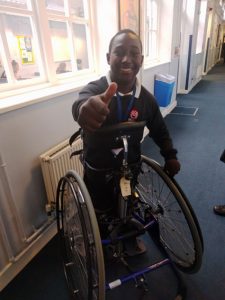 disabled boy giving a thumbs up sign