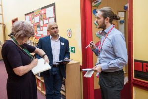 Headteacher Karl Hemmings talking in a corridor to Belinda and Navin
