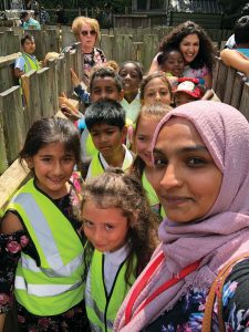 A group of students and staff from Seven Sisters school crowding in and smiling at the camera