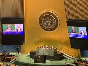 UN conference hall with stage and large television screens