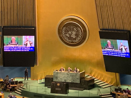 UN conference hall with stage and large television screens