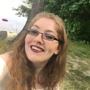 Photograph of Amelia McLoughlan, ALLFIE's Campaigns and Policy Coordinator, smiling to camera