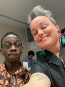 Left to right: Kihembo Wilbert, author, and colleague. Head and shoulders shot, they are both smiling to camera.
