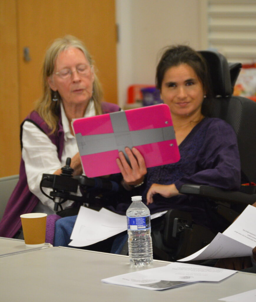 Maresa Mckeith, ALLFIE’s Youth Parliamentary Lead, presents her research for the upcoming Youth Parliamentary Group. The image shows Maresa and her PA using a communications board to present.